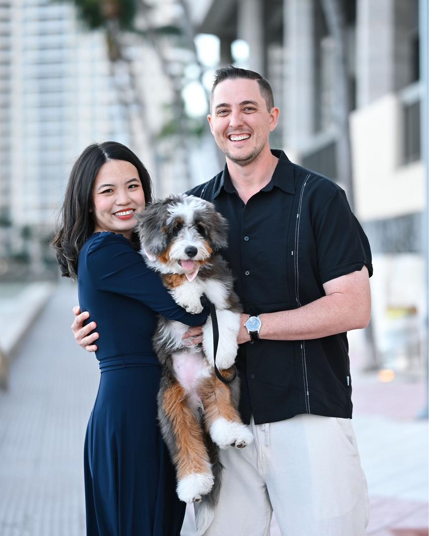 Happy family with their Bernedoodle